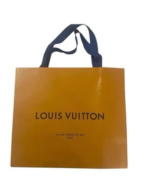 Louis Vuitton Traditional Orange Shopping Bag with cobalt blue handles.